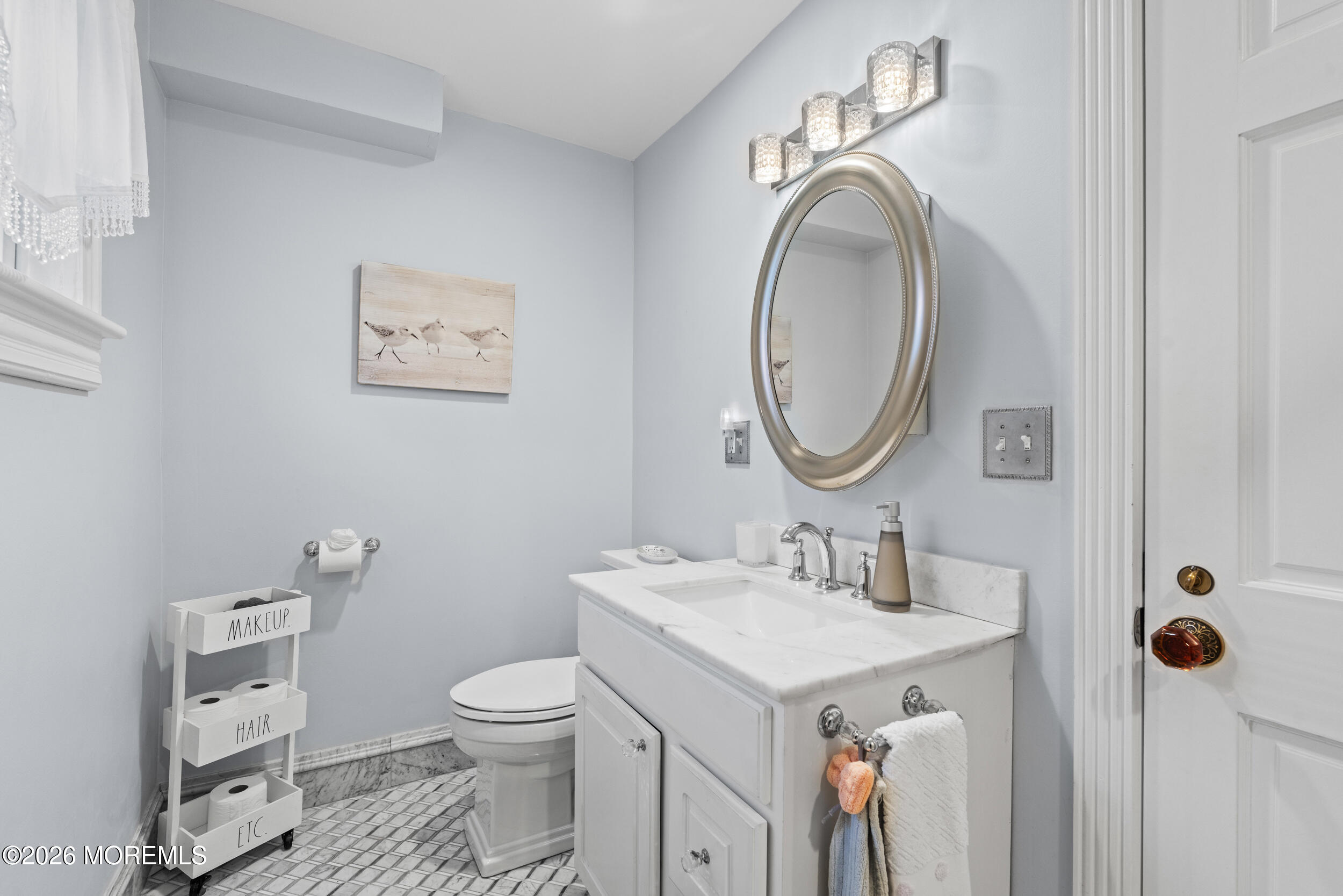 75 Webb Avenue, Unit UPPER WEEKLY Ocean Grove, NJ 07756 - Photo 17 of 41 a bathroom with a toilet sink and mirror