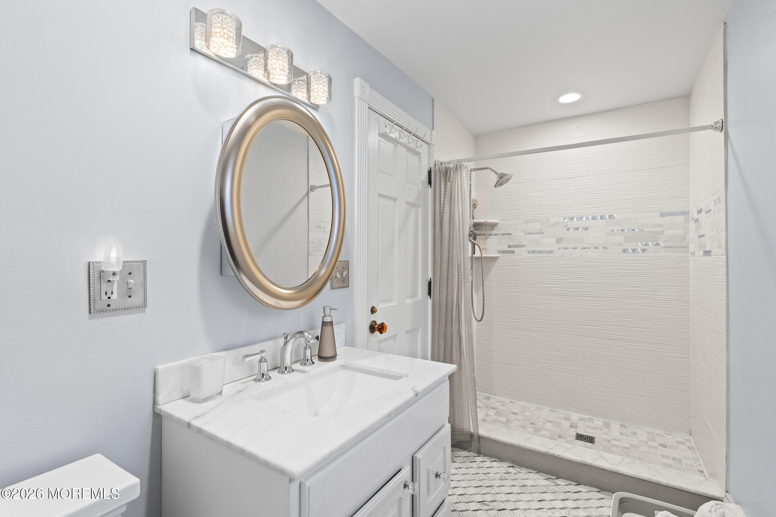 75 Webb Avenue, Unit UPPER WEEKLY Ocean Grove, NJ 07756 - Photo 18 of 41 a bathroom with a sink a mirror a vanity and a shower