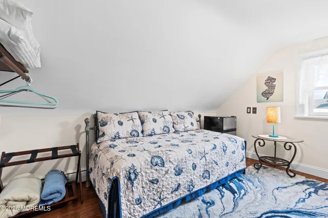 a bedroom with furniture and a wooden floor