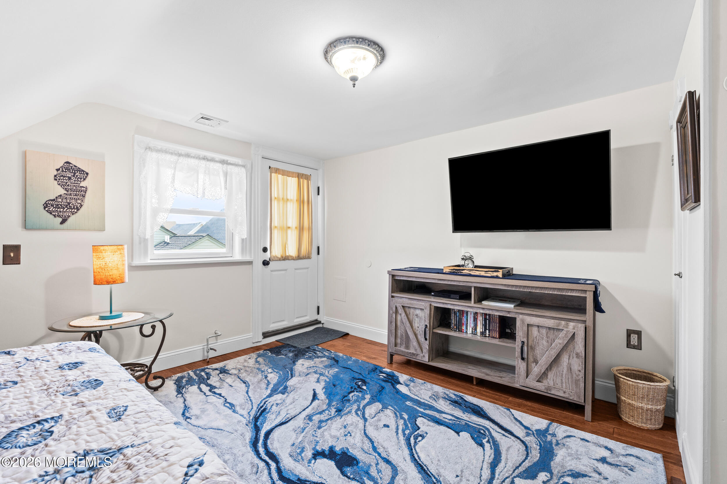 75 Webb Avenue, Unit UPPER WEEKLY Ocean Grove, NJ 07756 - Photo 29 of 41 a bedroom with a bed and a flat screen tv