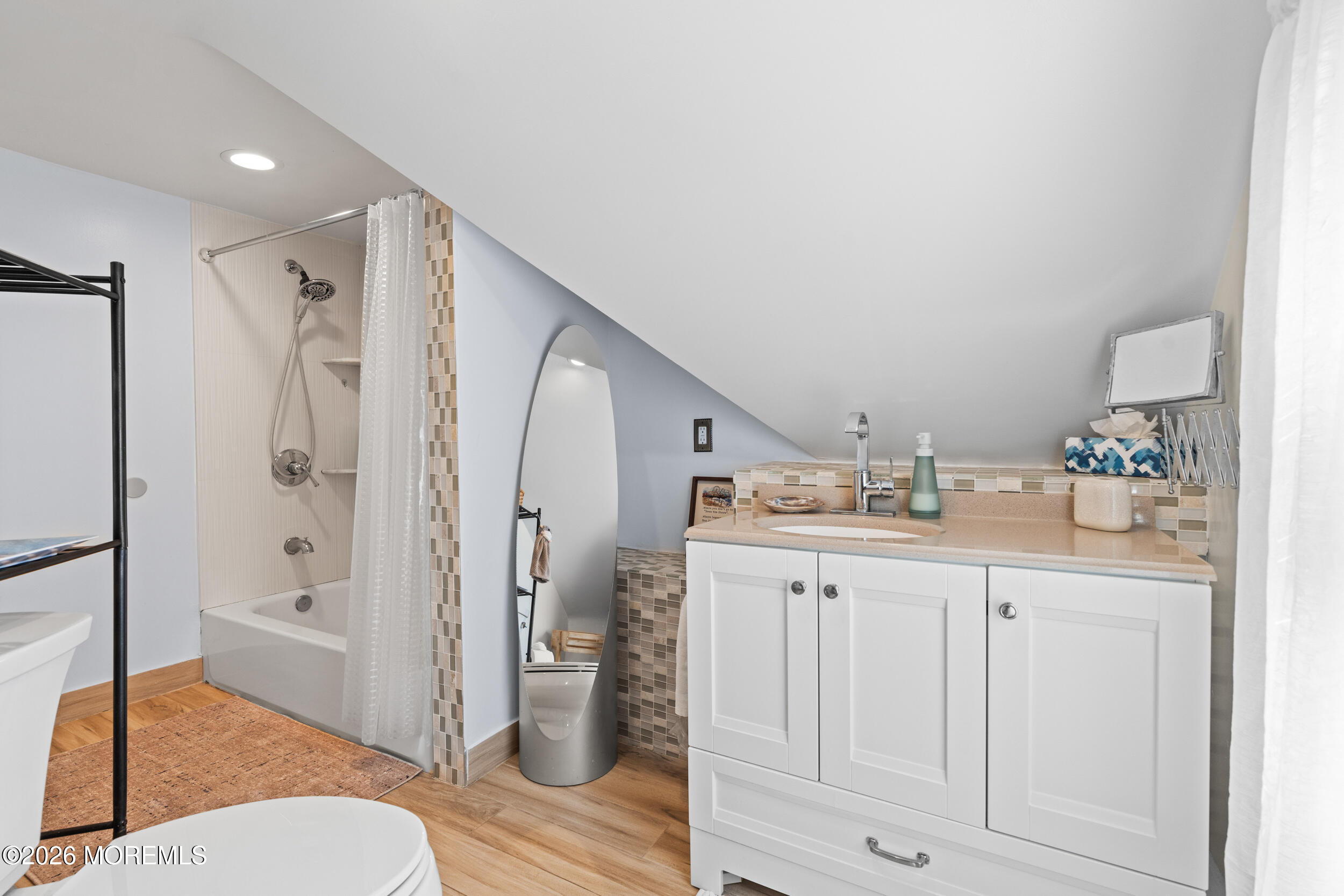 75 Webb Avenue, Unit UPPER WEEKLY Ocean Grove, NJ 07756 - Photo 32 of 41 a spacious bathroom with a granite countertop sink mirror vanity and toilet