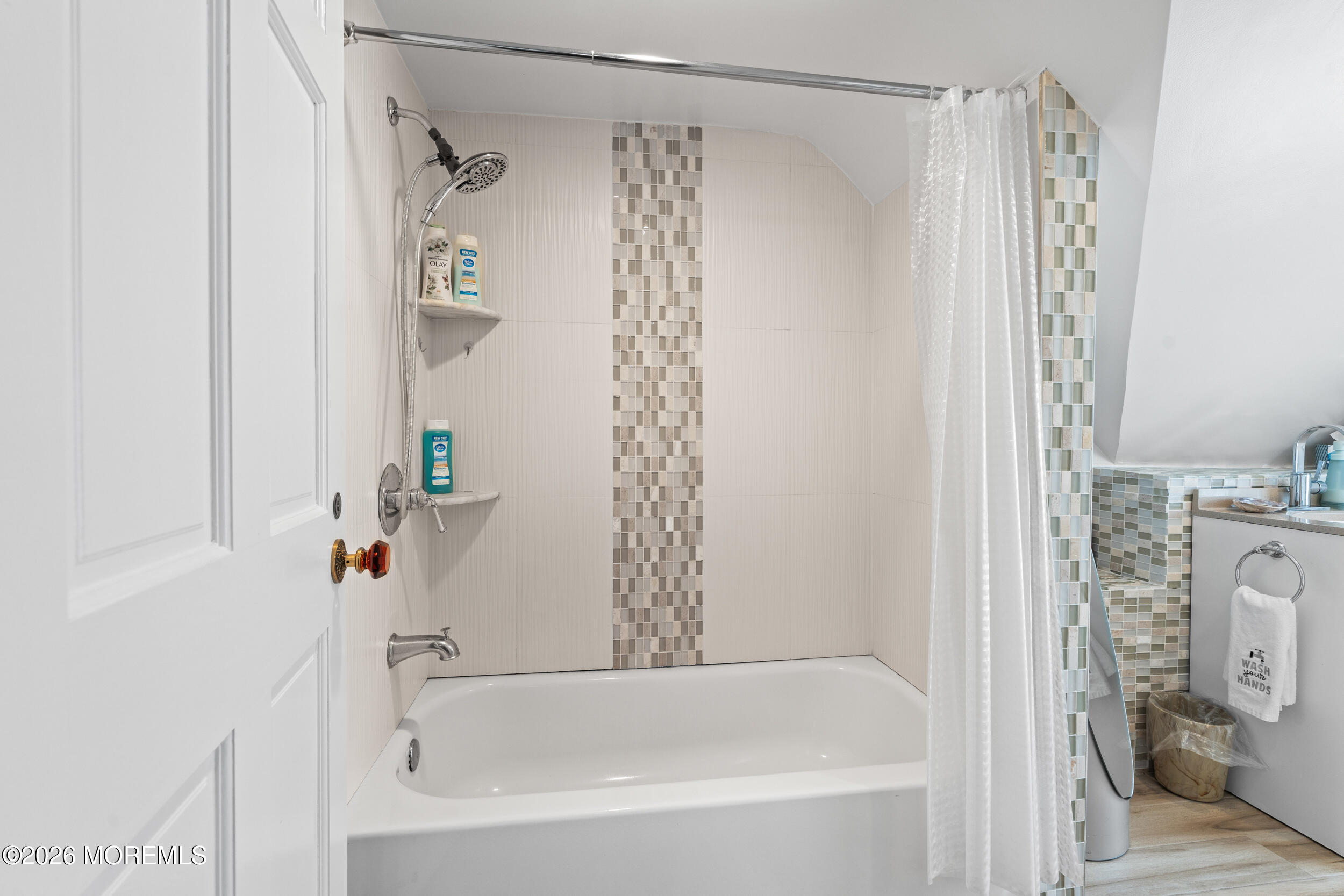 75 Webb Avenue, Unit UPPER WEEKLY Ocean Grove, NJ 07756 - Photo 33 of 41 a bathroom with a shower curtain and a bathtub