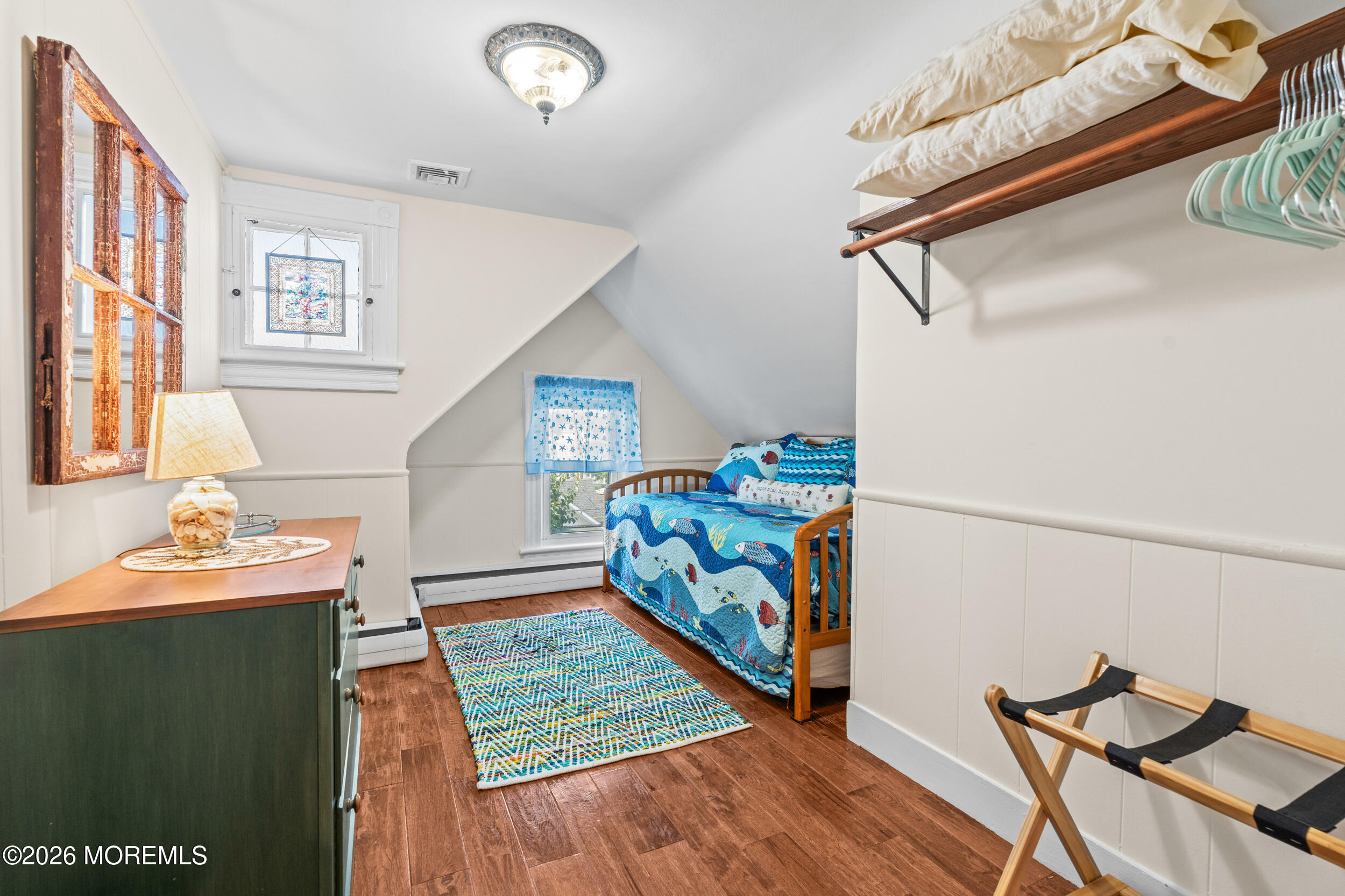 75 Webb Avenue, Unit UPPER WEEKLY Ocean Grove, NJ 07756 - Photo 35 of 41 a bedroom with furniture and a wooden floor