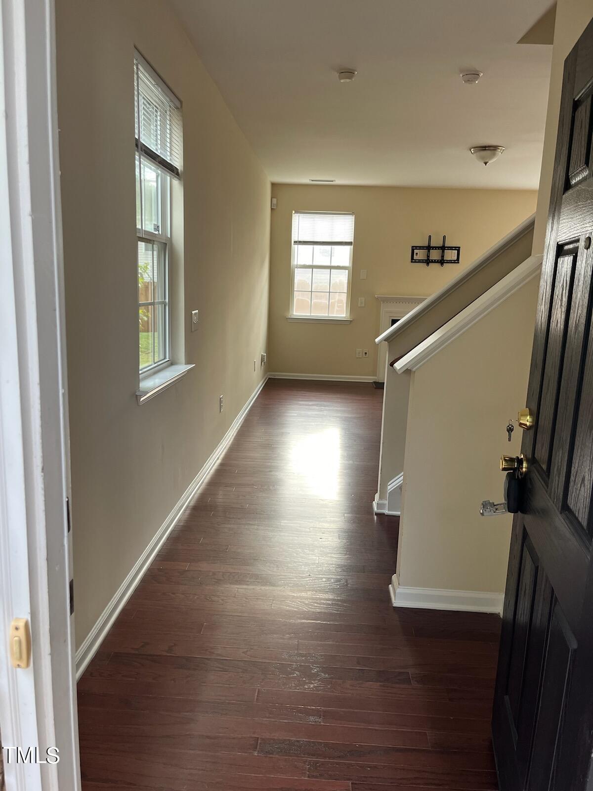 3622 Brideveil Court Raleigh, NC 27610 - Photo 2 of 12 a view of an empty room with wooden floor and windows