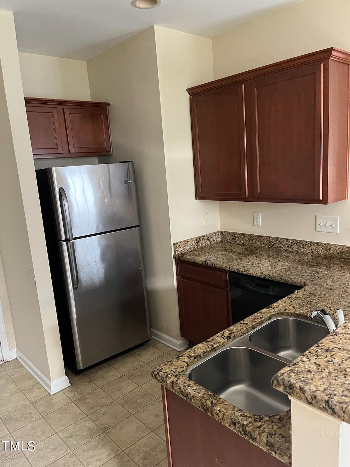3622 Brideveil Court Raleigh, NC 27610 - Photo 4 of 12 a kitchen with granite countertop a refrigerator and a sink