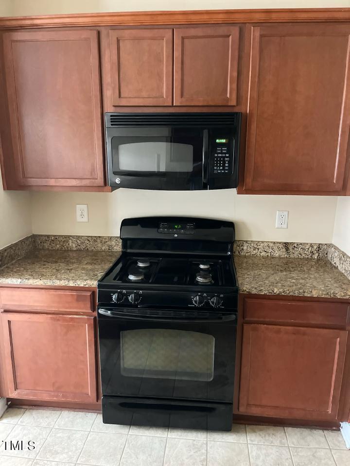 3622 Brideveil Court Raleigh, NC 27610 - Photo 5 of 12 a kitchen with granite countertop cabinets and steel stove top oven