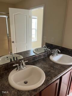 3622 Brideveil Court Raleigh, NC 27610 - Photo 10 of 12 a bathroom with a sink and a mirror