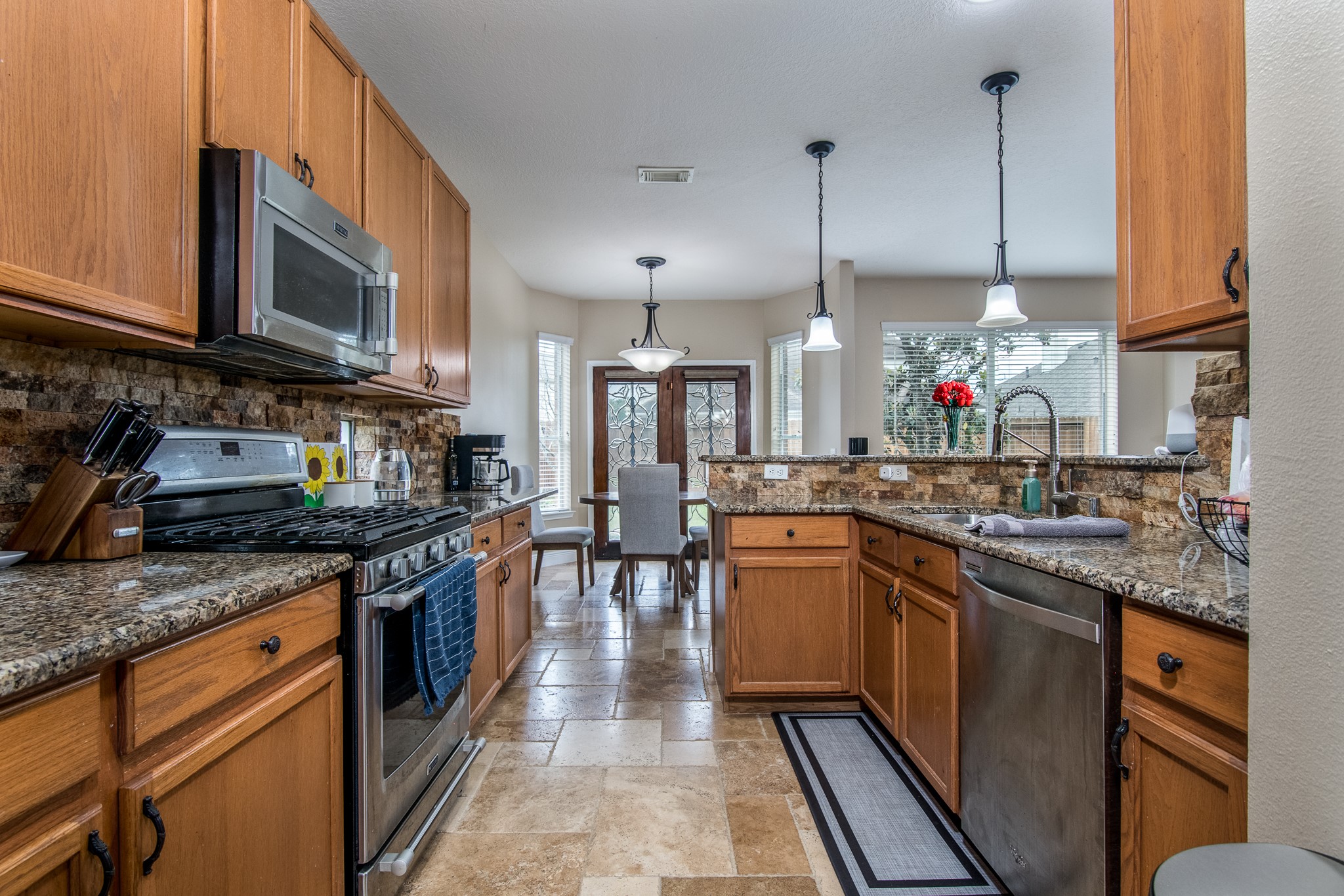 20011 Castlegreen Drive Spring, TX 77388 - Photo 10 of 32 Kitchen with granite counters and stainless appliances.