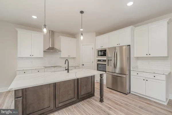 a kitchen with white cabinets stainless steel appliances and sink