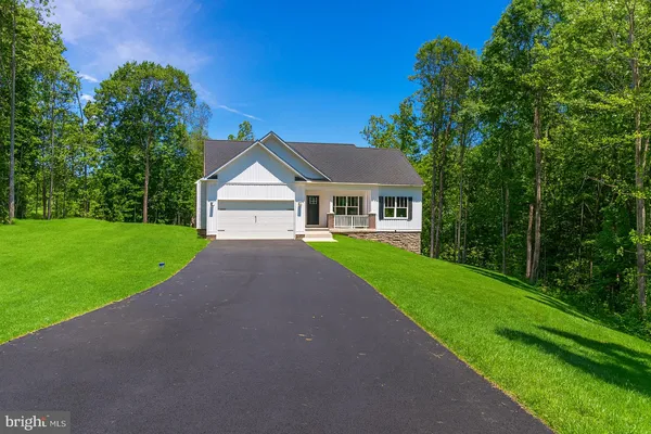 a view of house with a yard