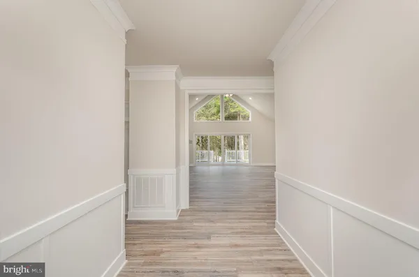 a view of hallway with wooden floor