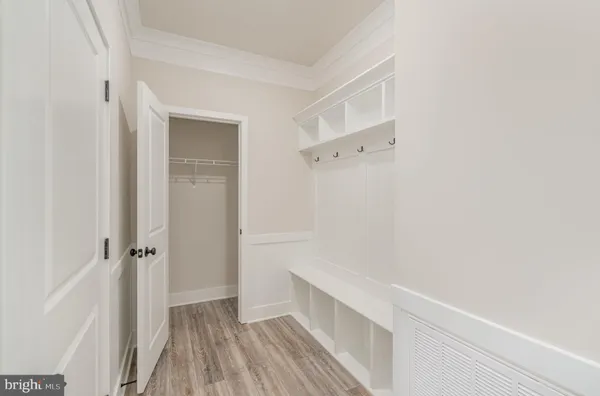 a view of an empty room with a kitchen and a window