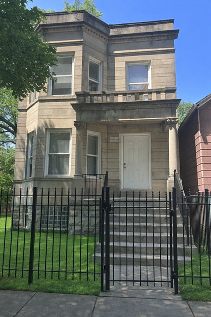 5320 South Carpenter Street Chicago, IL 60609 - Photo 1 of 5 a front view of a house with a garden
