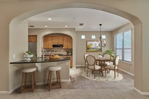 a kitchen with granite countertop a stove a sink and a granite counter tops