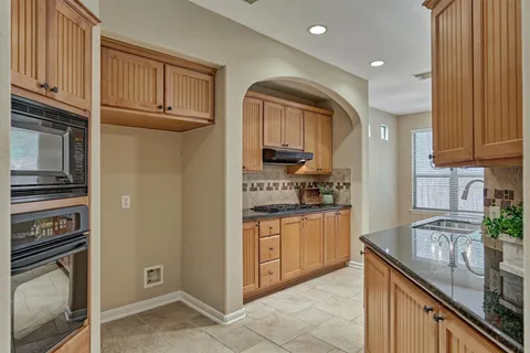 a spacious bedroom with a bed a couch and potted plant