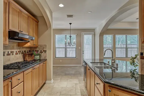 a view of a room with chandelier fan