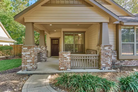 wooden floor fireplace and windows in an empty room