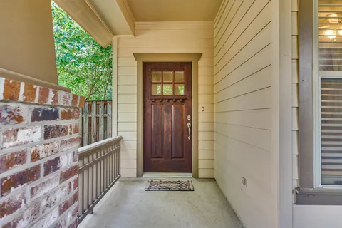 a living room with furniture a fireplace and a chandelier