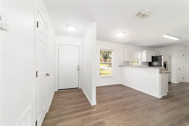 wooden floor in an empty room with a window