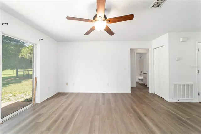 a view of kitchen with wooden floor and electronic appliances