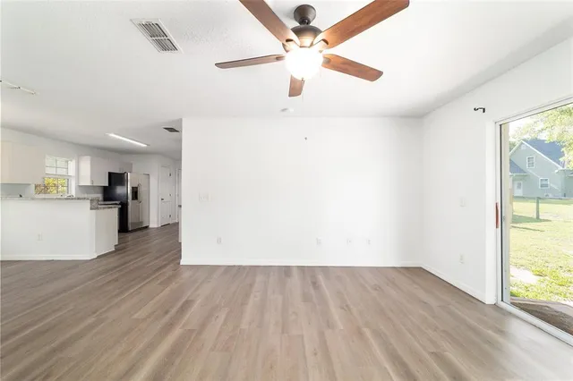 a kitchen with stainless steel appliances kitchen island granite countertop a refrigerator stove top oven and sink