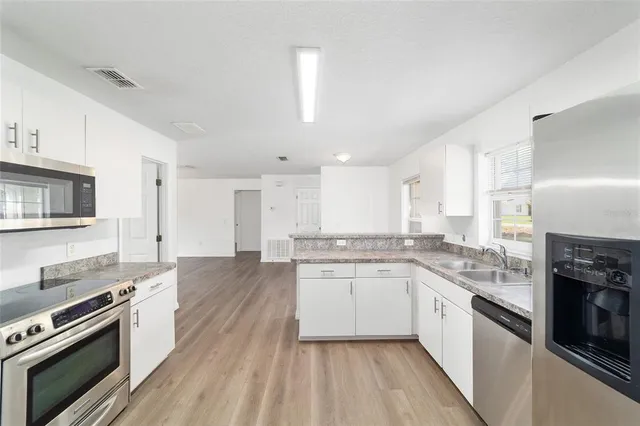 a bathroom with a toilet a sink and shower
