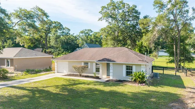 a front view of a house with a yard table and chairs