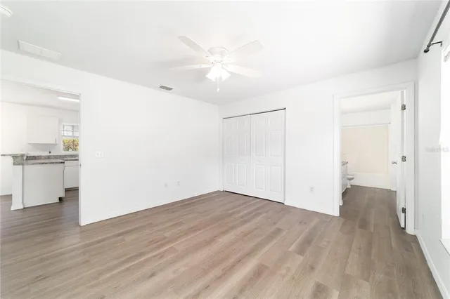 a view of a house with a yard and large tree