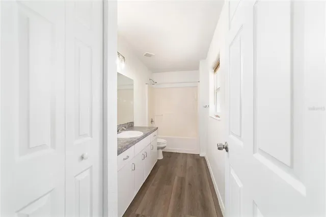 a view of a house with a backyard and a tree