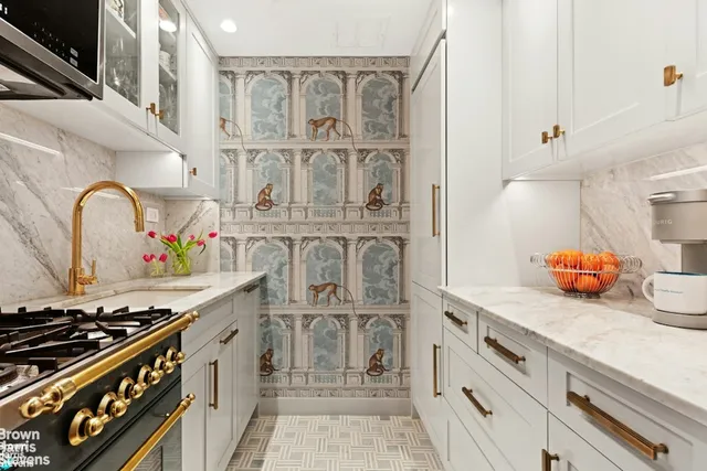 a kitchen with cabinets and stove