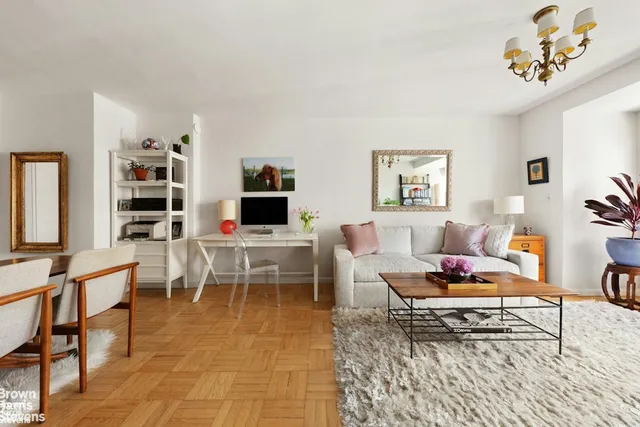 a living room with furniture a rug and a window