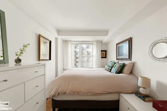 a bedroom with a large bed and a window