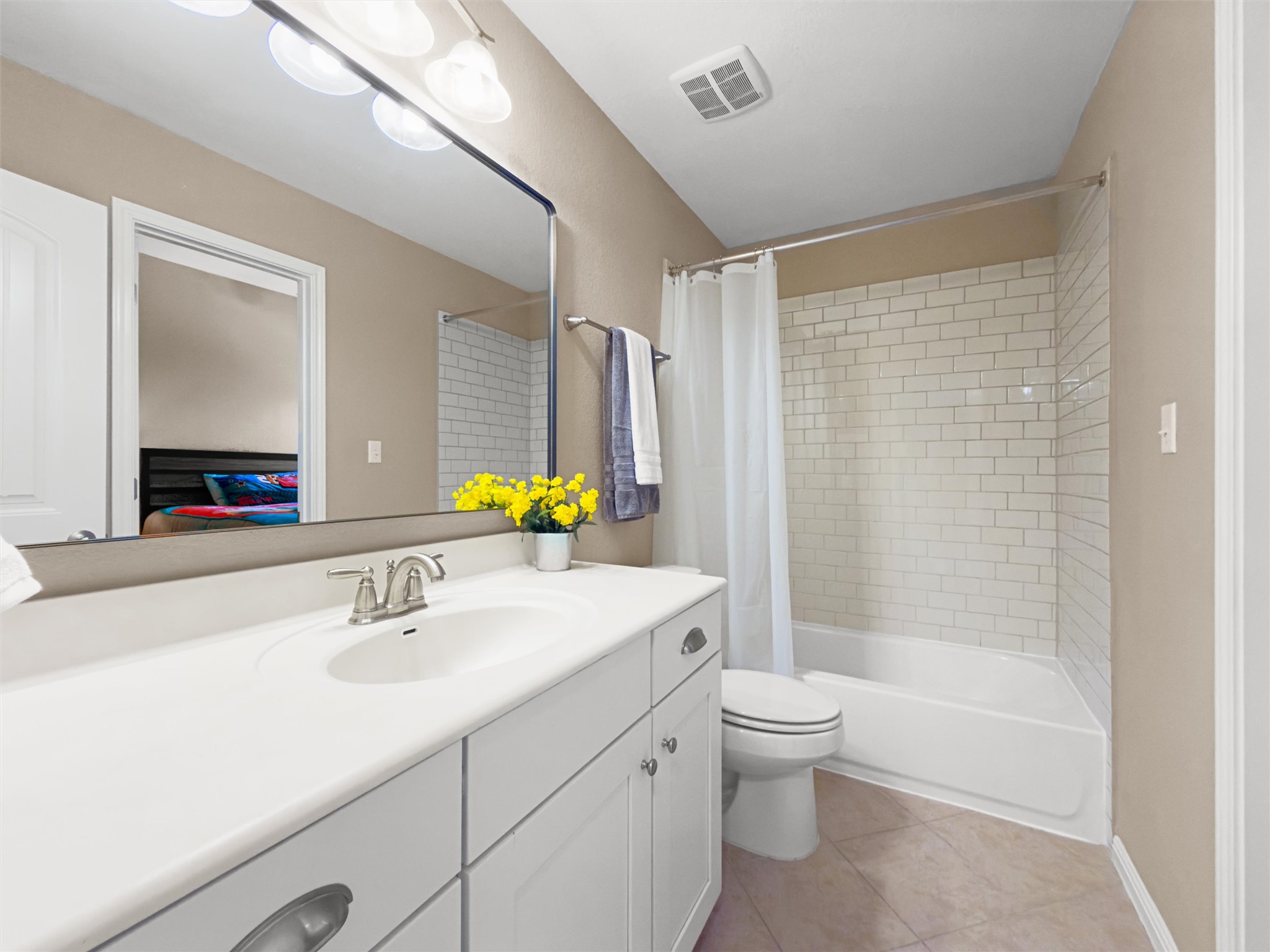 7716 Aria Loop Austin, TX 78736 - Photo 27 of 39 A pristine bathroom features a vanity, a toilet, and a subway-tiled shower-tub combination.