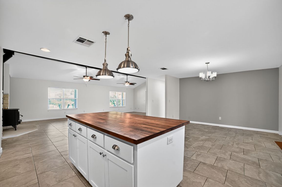313 Starview Drive Georgetown, TX 78628 - Photo 12 of 38 a kitchen with kitchen island a sink a counter space and appliances