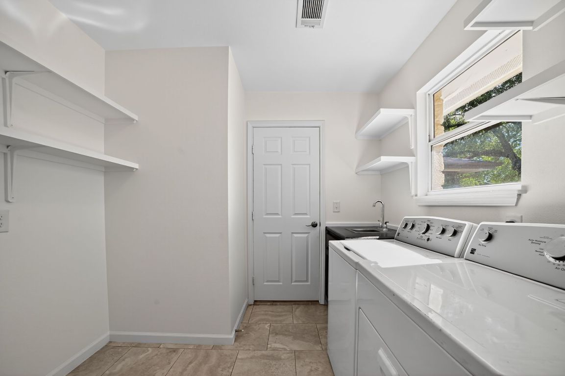 313 Starview Drive Georgetown, TX 78628 - Photo 18 of 38 a utility room with a window dryer and washer
