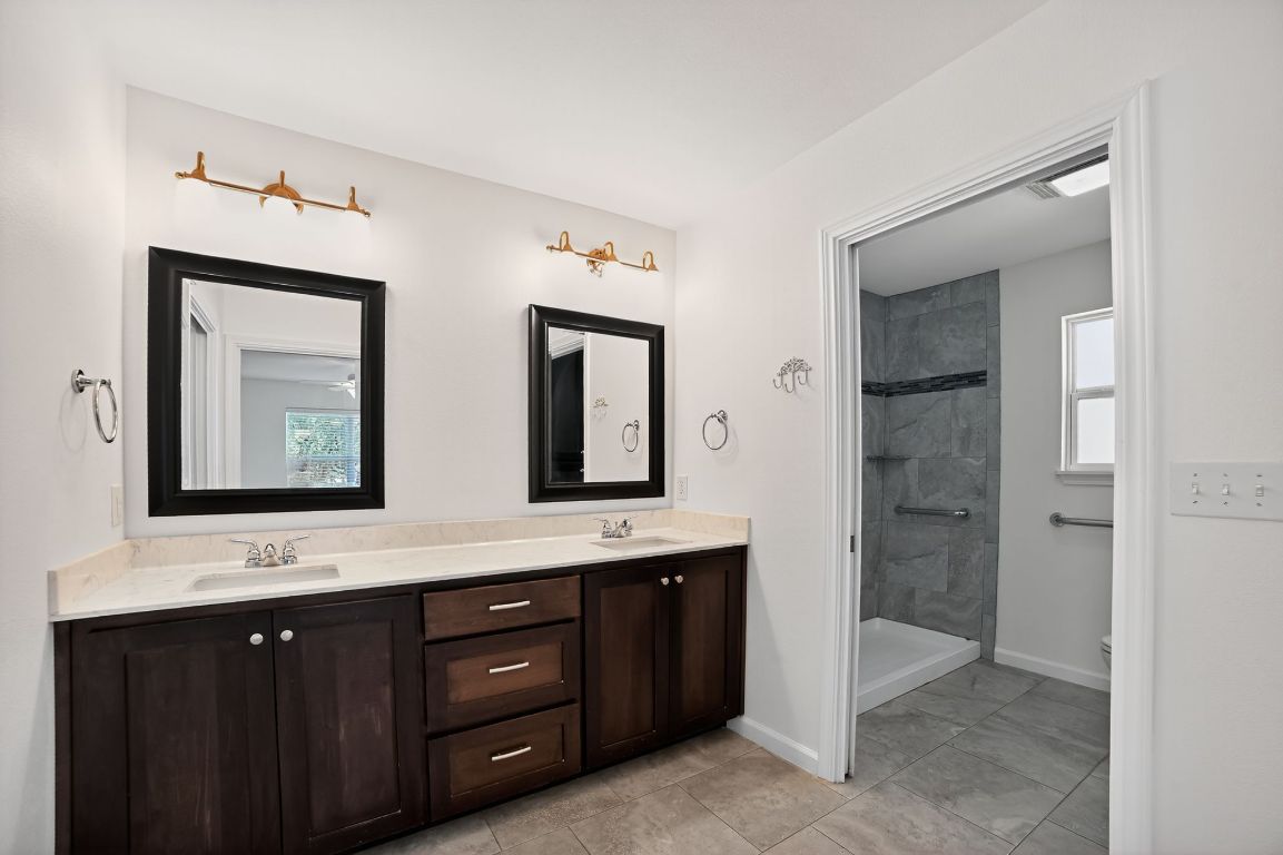 313 Starview Drive Georgetown, TX 78628 - Photo 24 of 38 a bathroom with a double vanity sink and a mirror