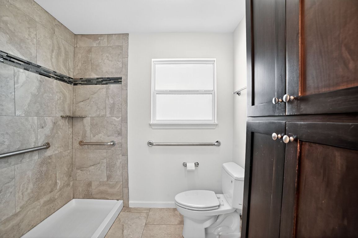 313 Starview Drive Georgetown, TX 78628 - Photo 25 of 38 a bathroom with a granite countertop bathtub shower sink and toilet
