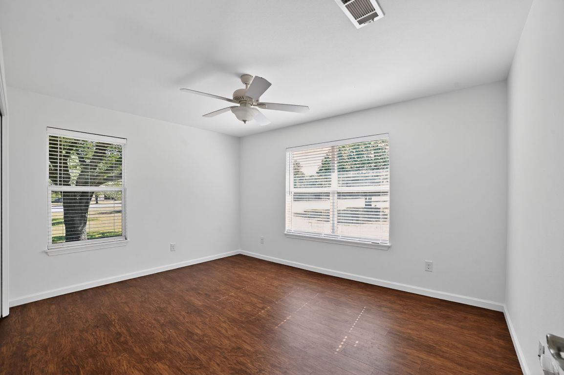 313 Starview Drive Georgetown, TX 78628 - Photo 27 of 38 an empty room with wooden floor and windows