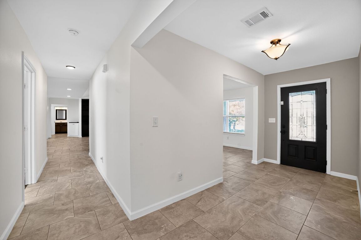 313 Starview Drive Georgetown, TX 78628 - Photo 6 of 38 wooden floor in a hall with an entryway and a livingroom