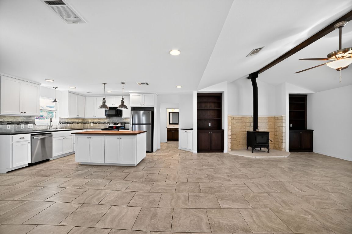 313 Starview Drive Georgetown, TX 78628 - Photo 9 of 38 a large kitchen with a large counter top and stainless steel appliances