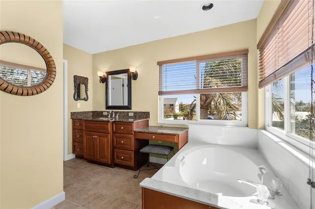 a bathroom with a granite countertop toilet sink and mirror