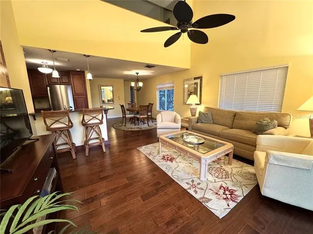 a living room with furniture and a floor to ceiling window