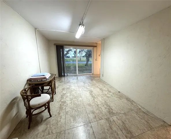 a view of pool with a bench and lawn chair