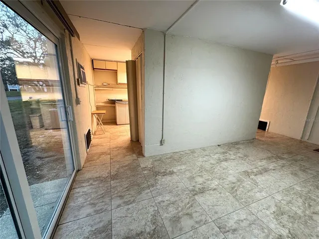 an aerial view of a house with a garden and lake view