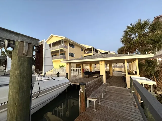 an aerial view of a residential houses with outdoor space and lake view