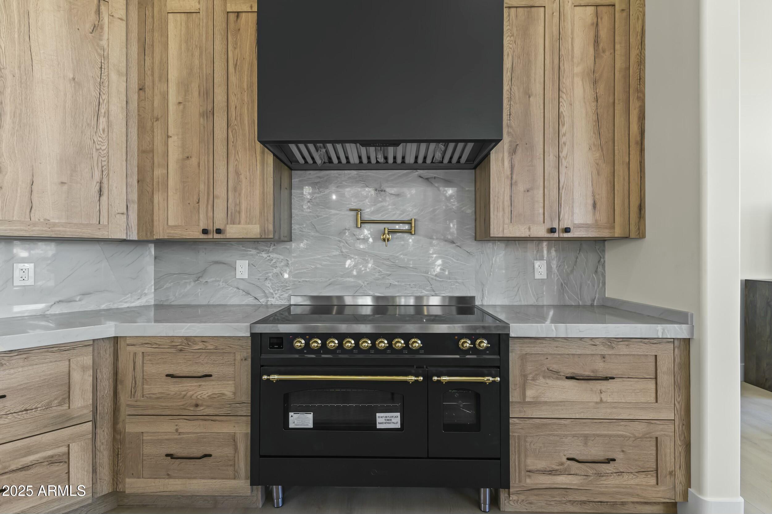 7705 East Doubletree Ranch Road, Unit 21 Scottsdale, AZ 85258 - Photo 12 of 45 a stove top oven sitting inside of a kitchen