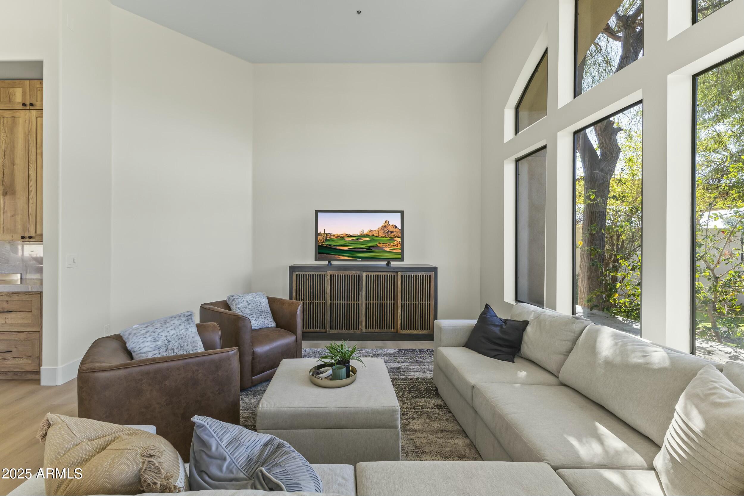 7705 East Doubletree Ranch Road, Unit 21 Scottsdale, AZ 85258 - Photo 18 of 45 a living room with furniture and a flat screen tv
