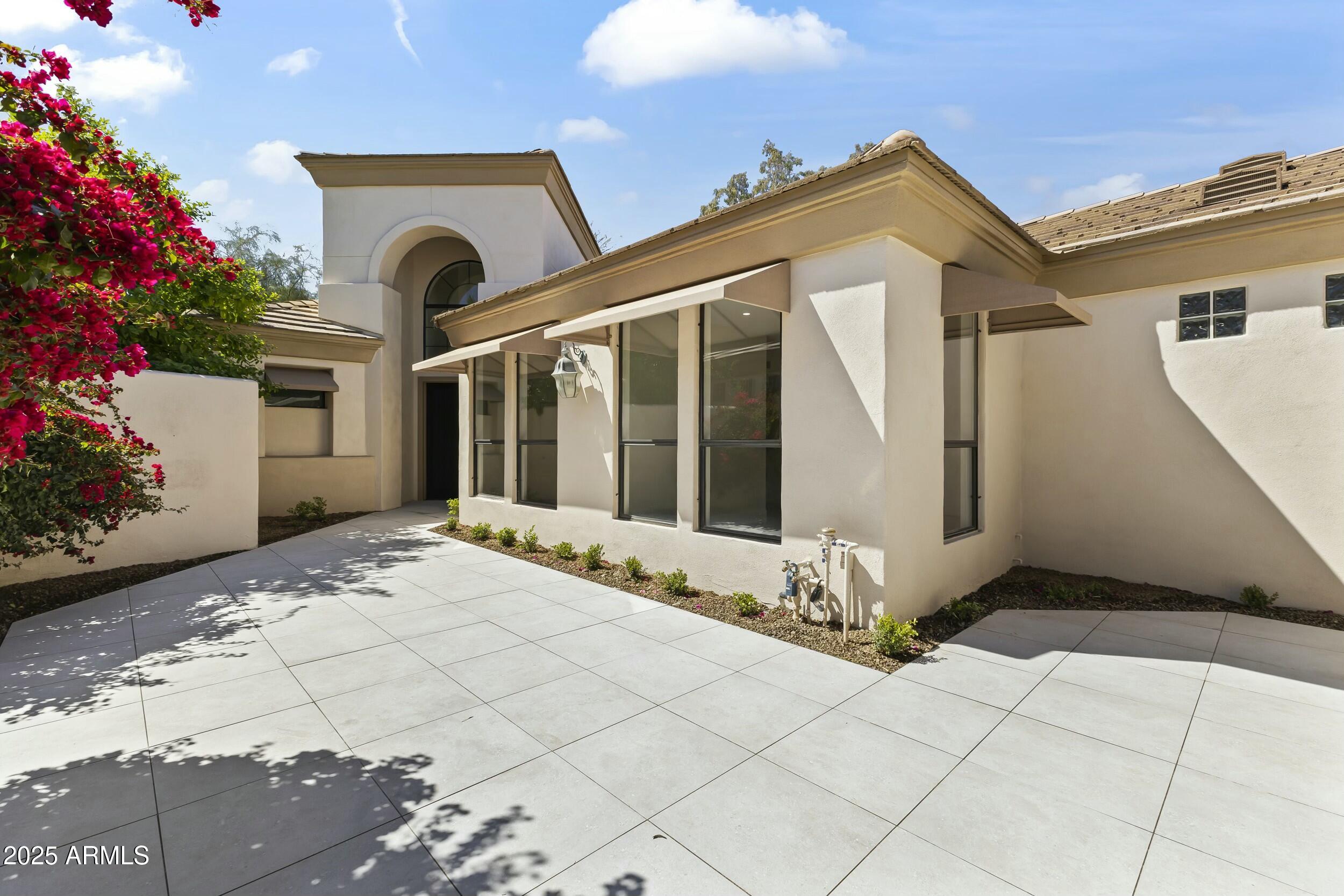7705 East Doubletree Ranch Road, Unit 21 Scottsdale, AZ 85258 - Photo 2 of 45 a front view of a house with a yard