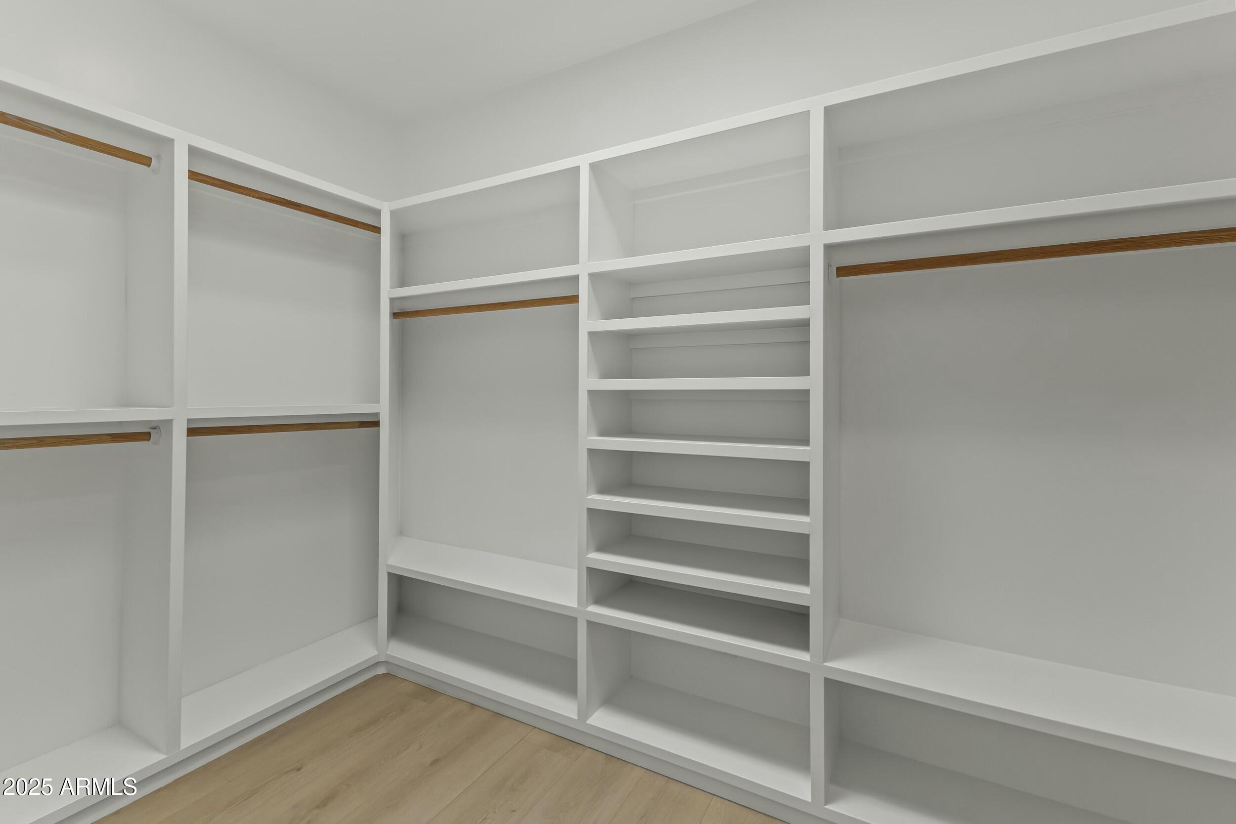 7705 East Doubletree Ranch Road, Unit 21 Scottsdale, AZ 85258 - Photo 23 of 45 a view of walk in closet with empty racks