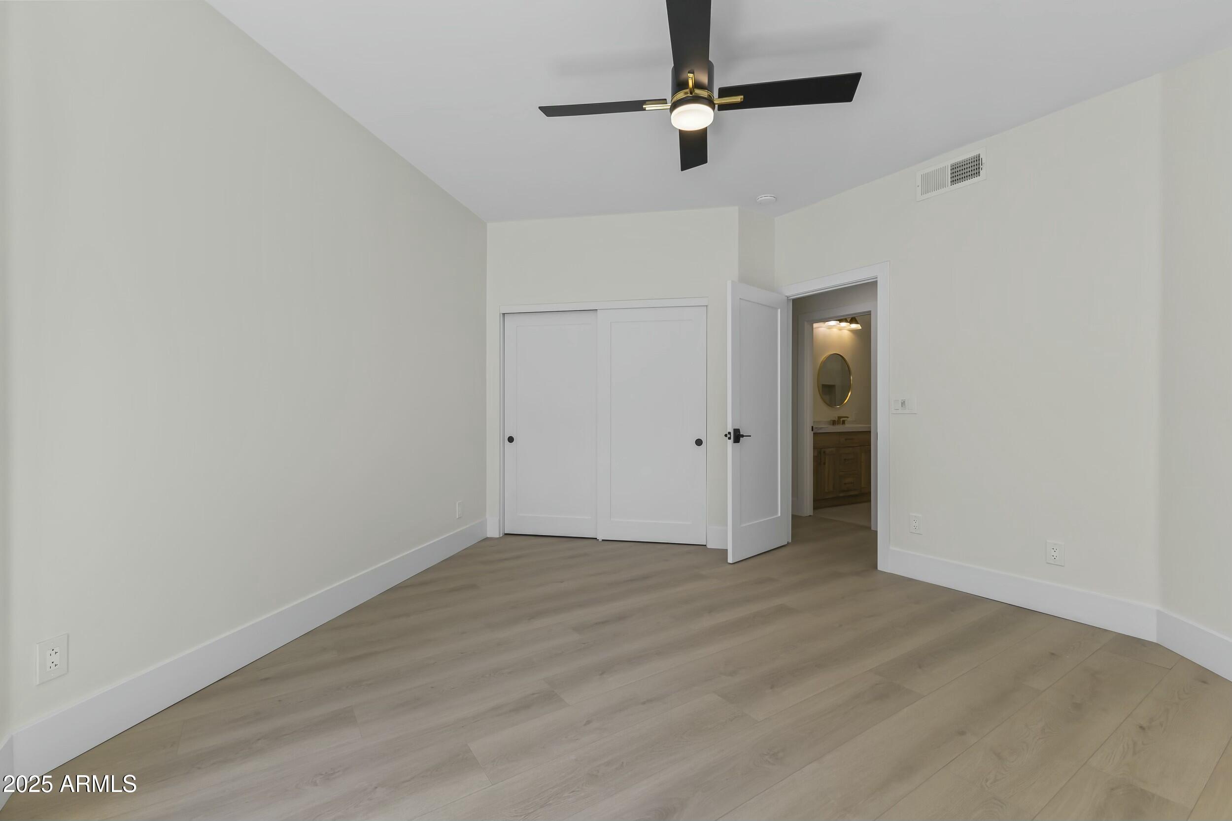 7705 East Doubletree Ranch Road, Unit 21 Scottsdale, AZ 85258 - Photo 27 of 45 an empty room with closet and a ceiling fan